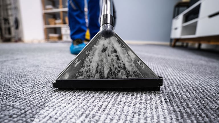 Close-up Of A Cleaning Carpet With Vacuum Cleaner Credit: AndreyPopov