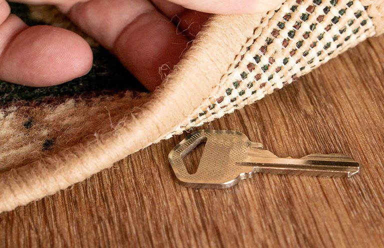 person handing another person a house key
