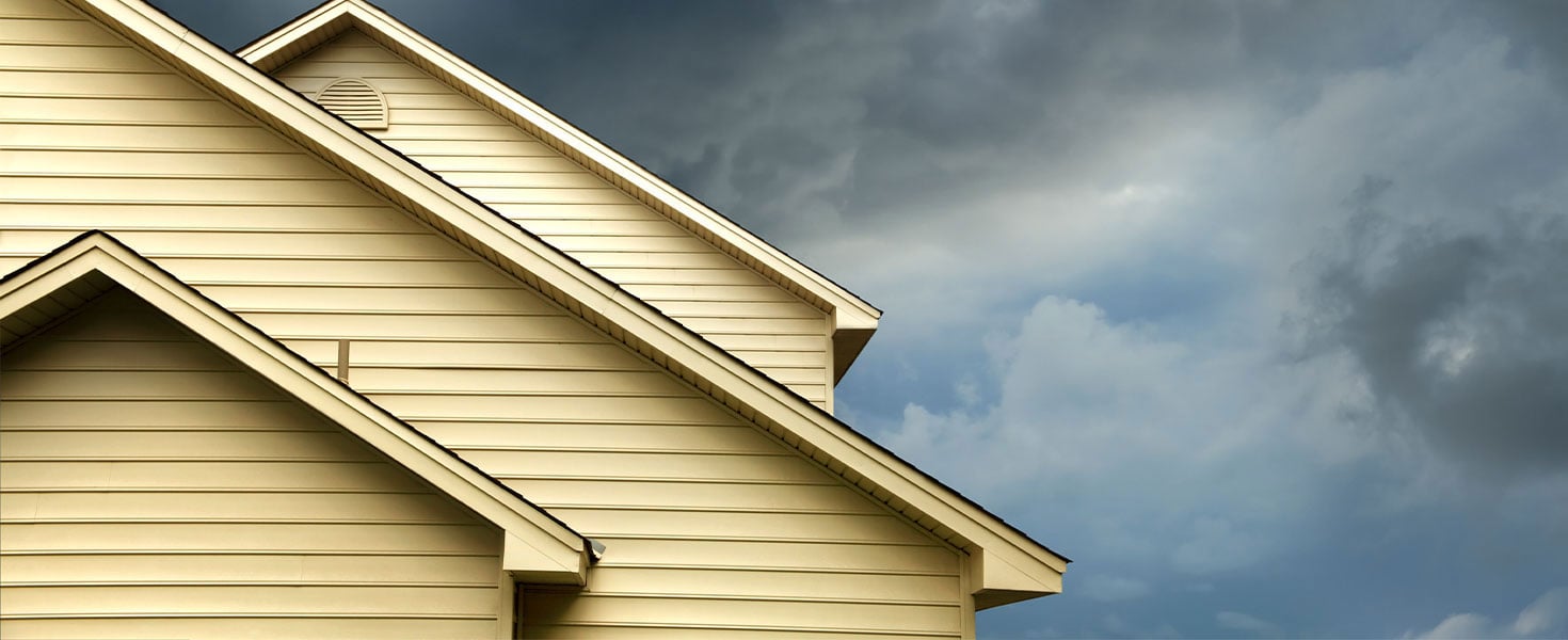 stormy sky behind top of house