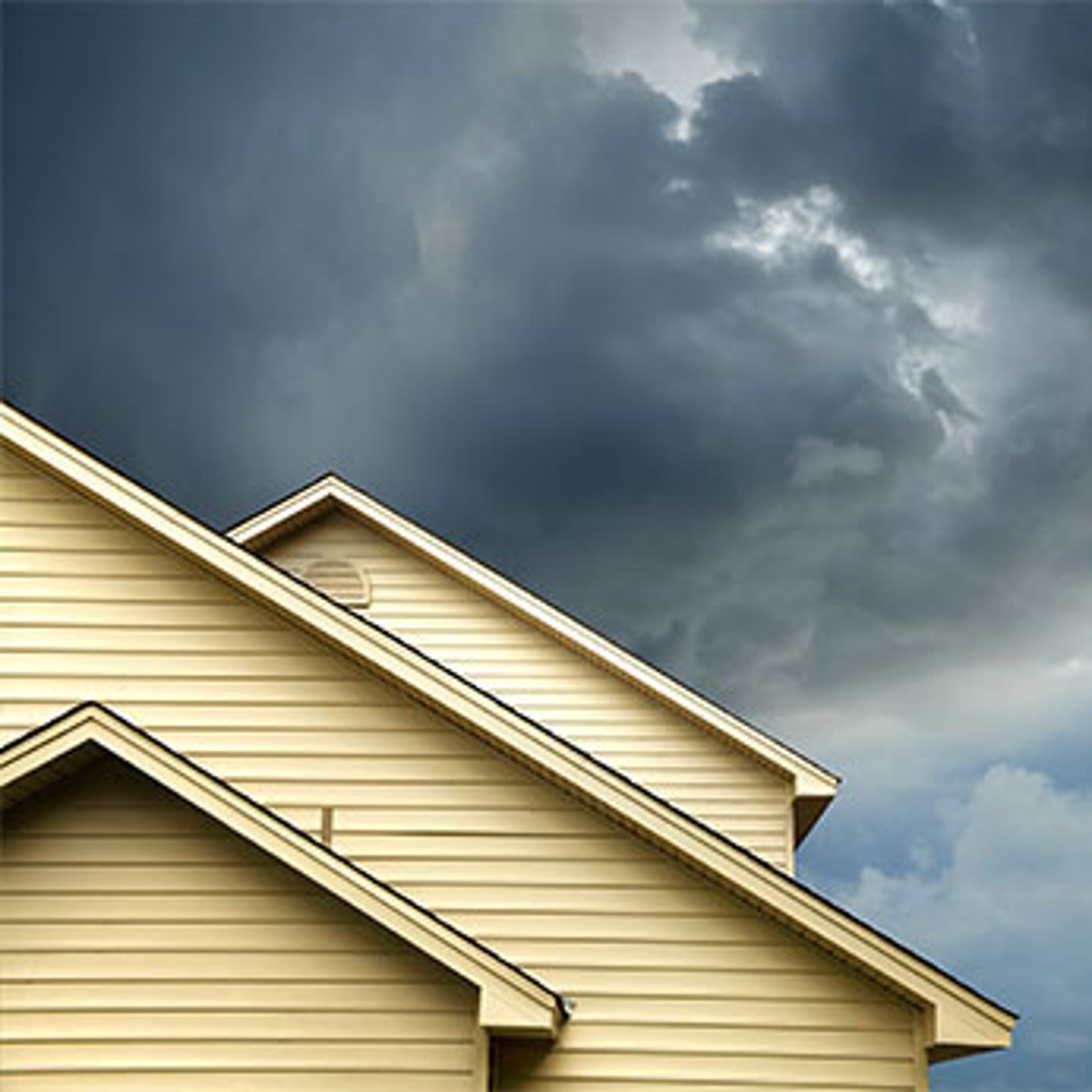 stormy sky behind top of house