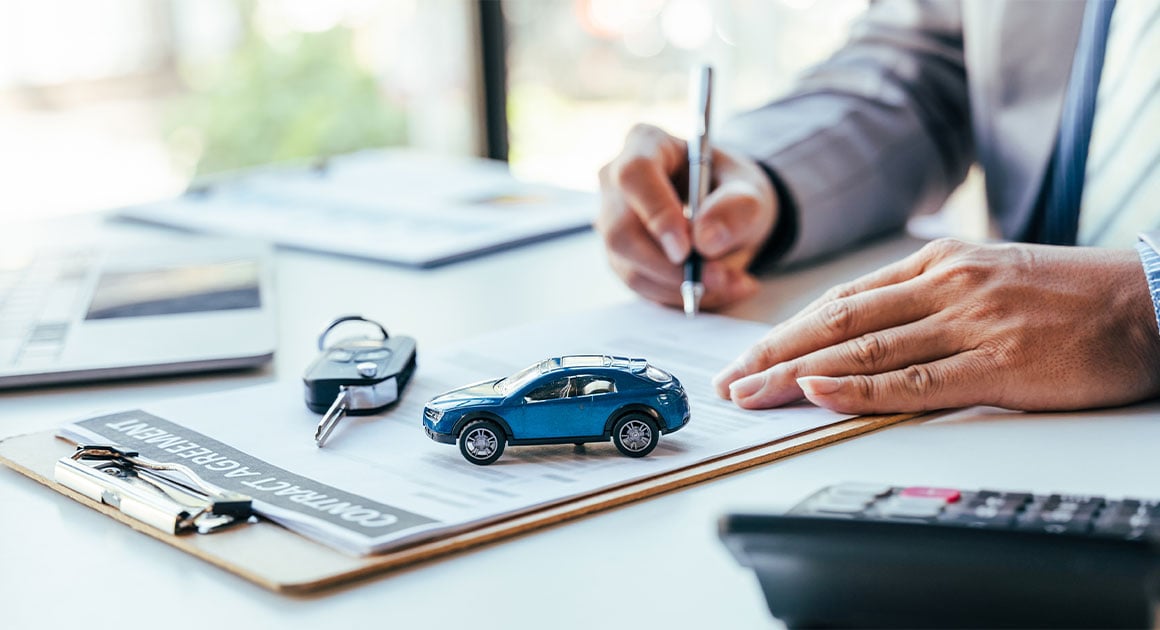 man signing insurance forms