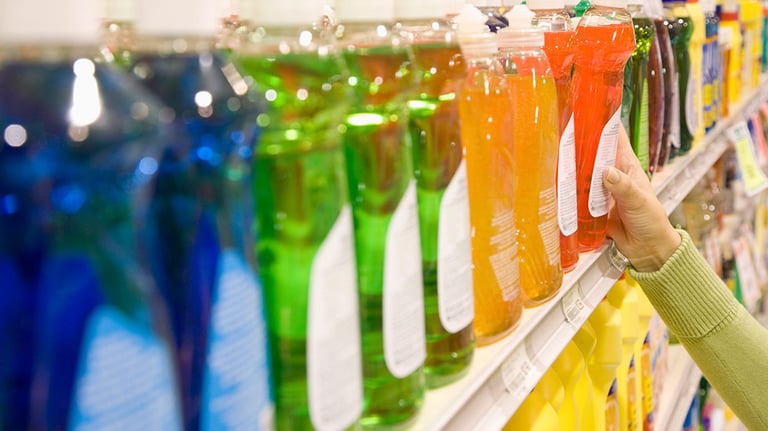 Woman selecting dishwashing liquid product in supermarket. Credit: FangXiaNuo
