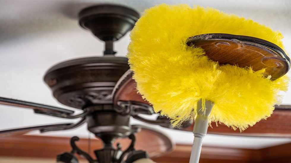 ceiling fan being dusted
