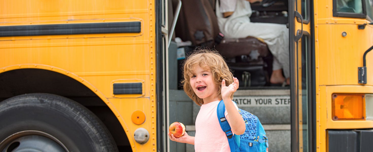 kid in front of school bus