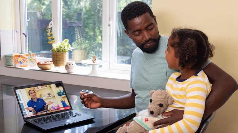 father and kid having a virtual doctor appointment 