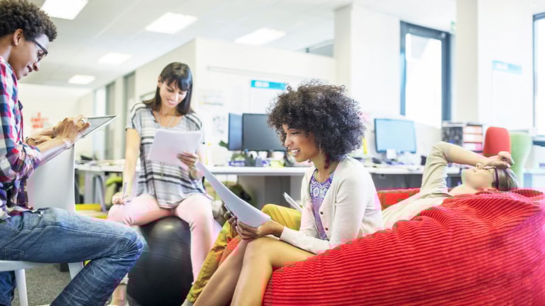 Office workers sitting on bean bag chairs