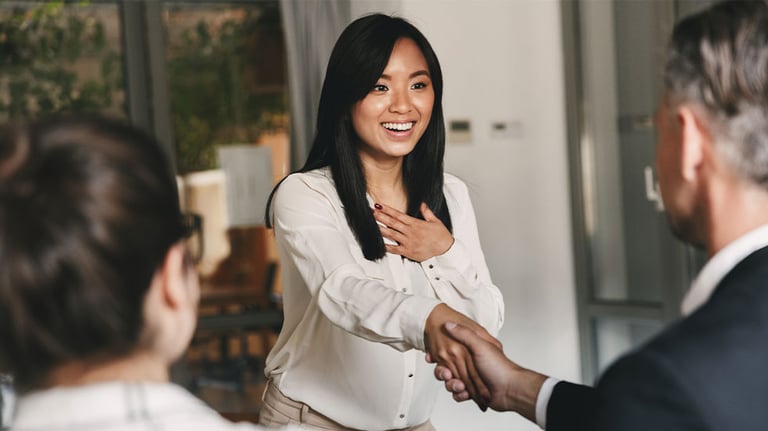 woman shaking man's hand