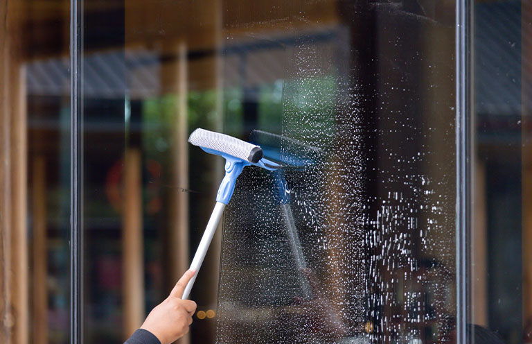 window being cleaned with squeegee