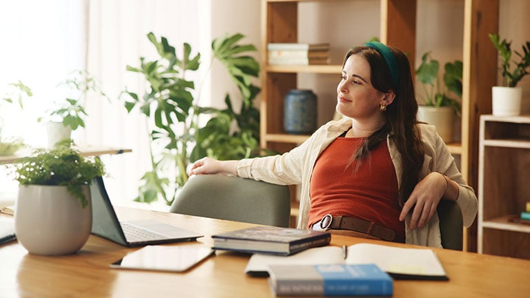 Student, smile and relax with girl in home office for research assignment, college thesis and satisfaction. Education, calm and learning with person studying for university, school and project;  Credit: Jacob Wackerhausen