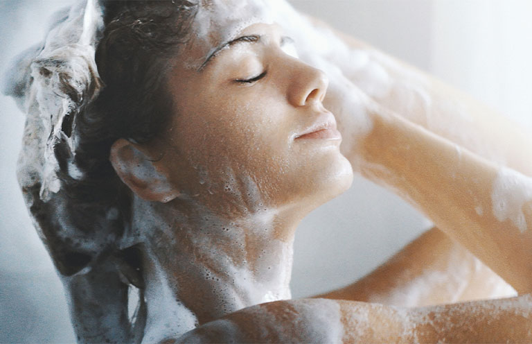woman washing her hair in shower