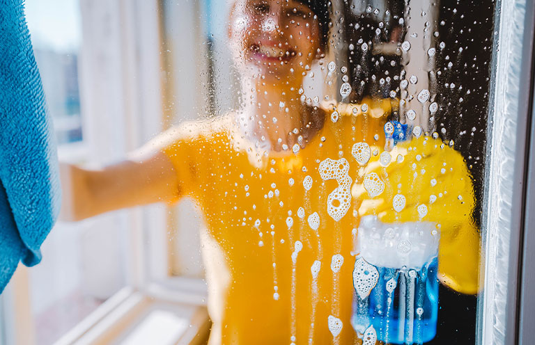 woman cleaning window
