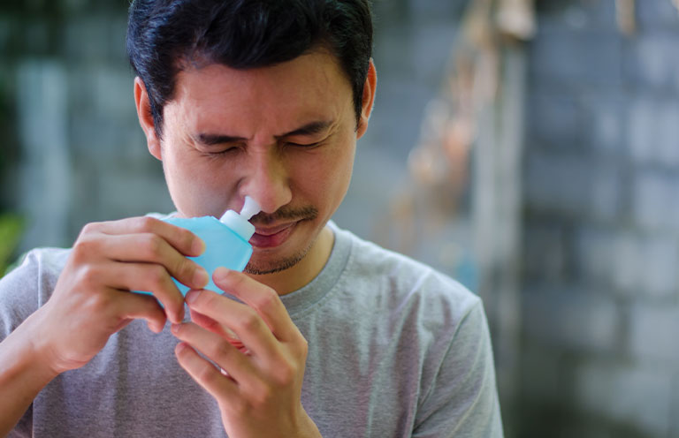 man using saline rinse