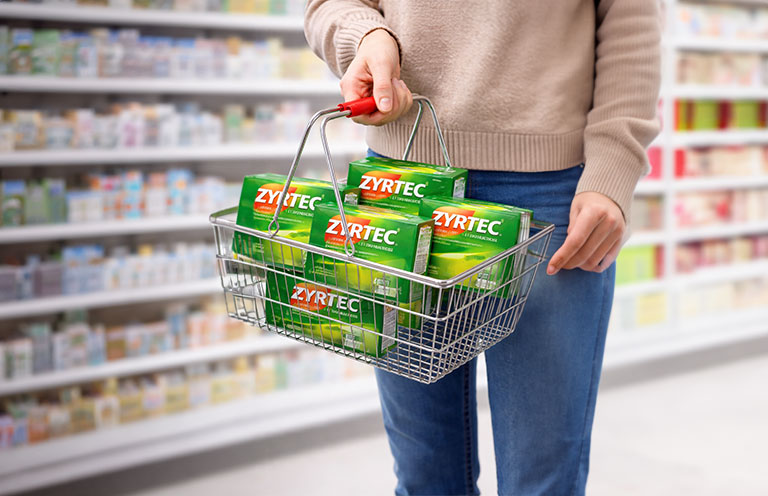 man holding basket of Zyrtec medication