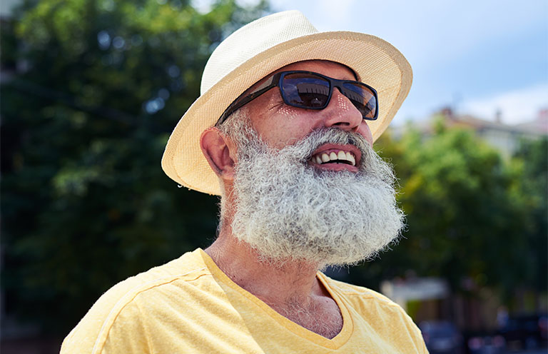man outside wearing hat and sunglasses