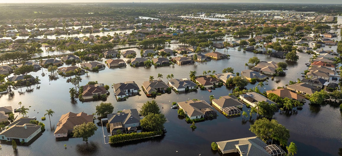 Flooded houses from hurricane rainfall water in Florida residential community. Aftermath of natural disaster in USA south. Credit: Bilanol