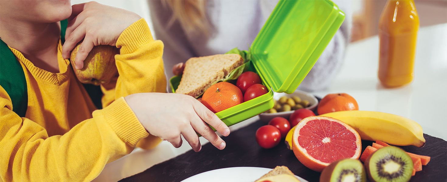 Mother and child with healthy school lunch