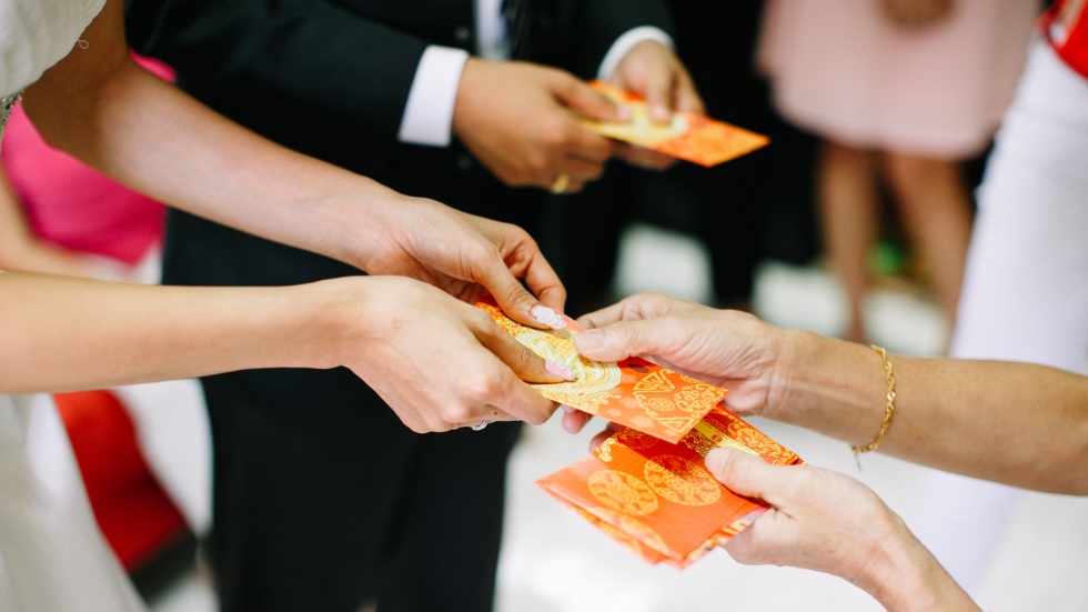 Couple giving gift envelopes