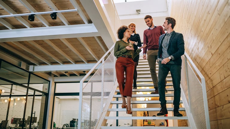coworkers walking down staircase