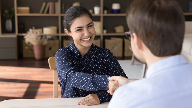 Woman shaking a man's hand during interview