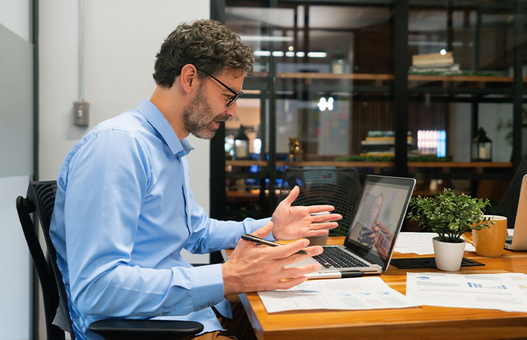 man on video call on laptop