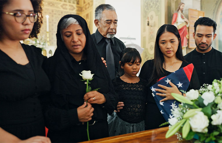 people at a funeral in front of casket