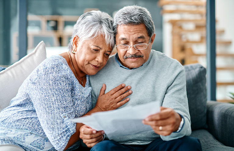 elder couple looking at documents