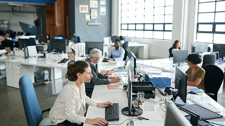 Colleagues working on their computers. Credit: Yuri_Arcurs