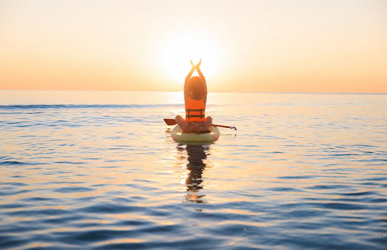 girl sitting on a paddleboard