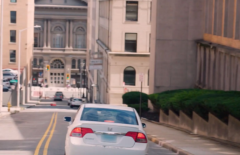 car driving down local street in Worcester MA