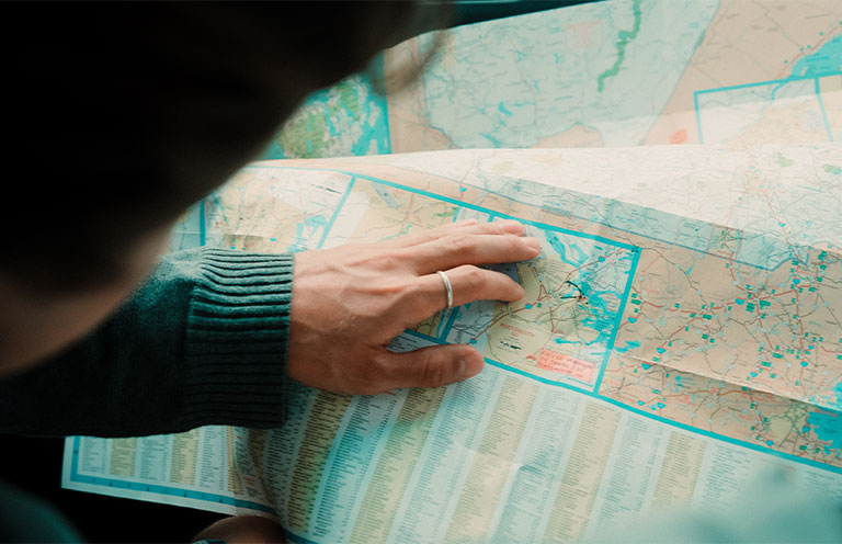 person pointing at map