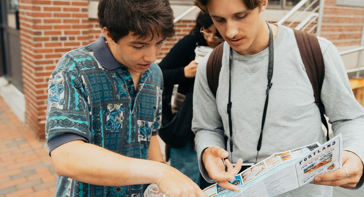 two people looking at a map of Portland, Maine