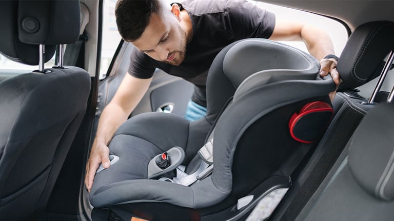 man installing car seat