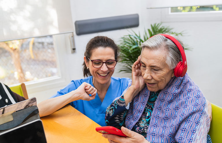 elder man with headphones on, sound therapy