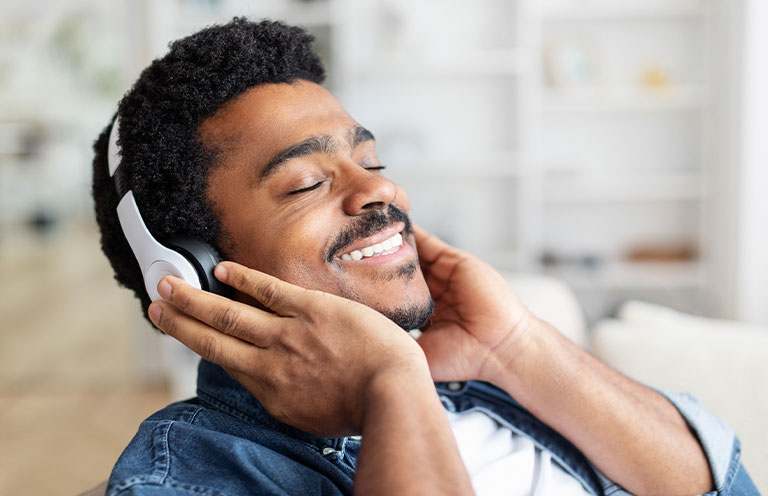 man smiling with headphones on