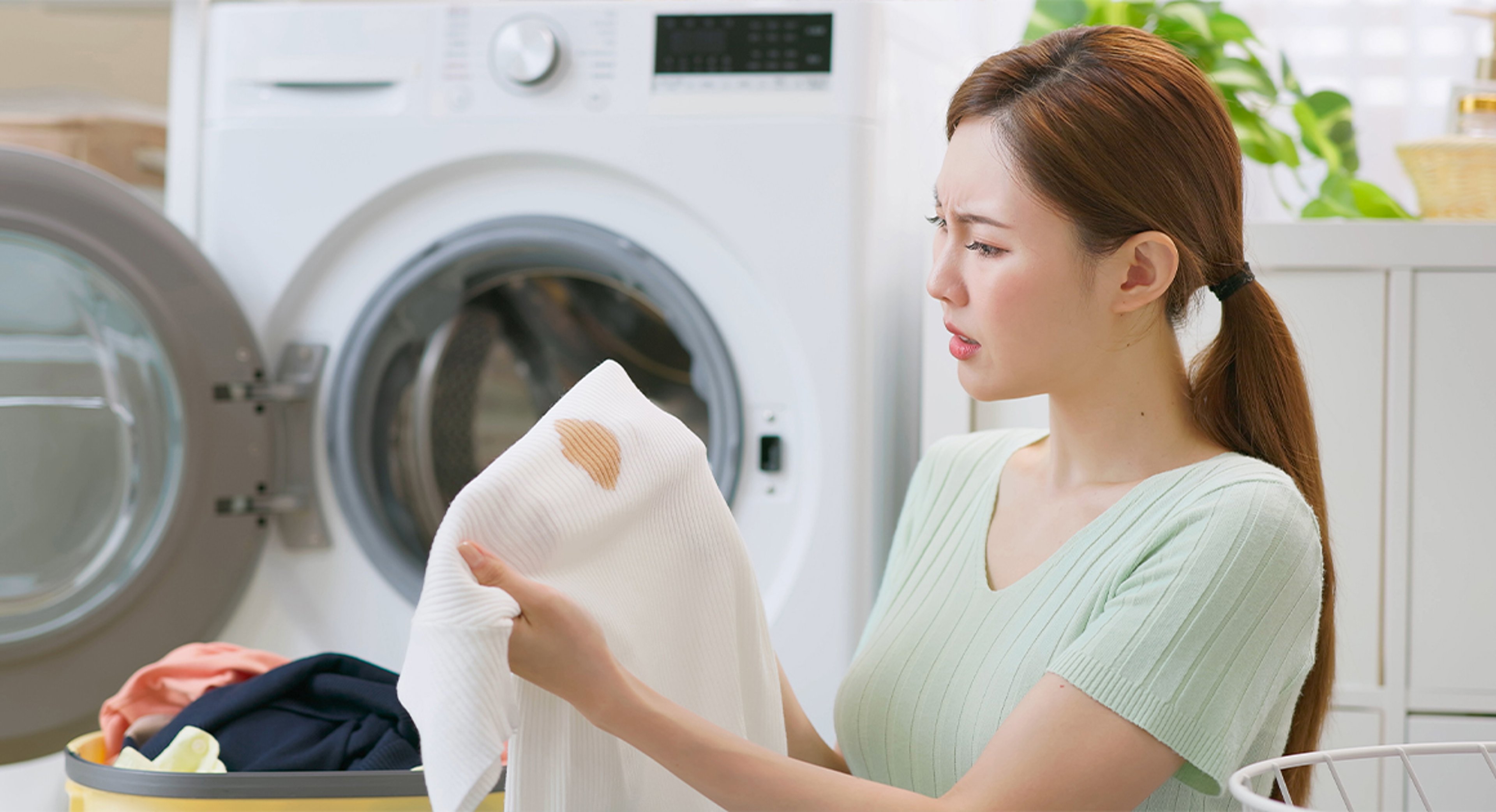 woman looking at stain on a shirt