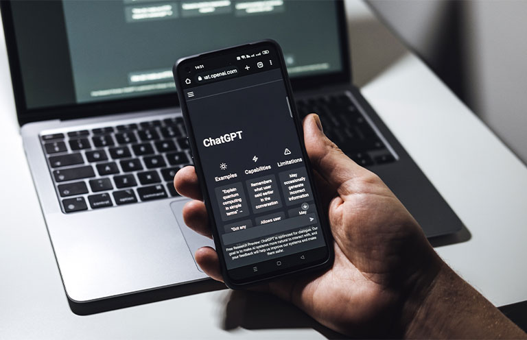 Person holding phone with Chat GPT app open