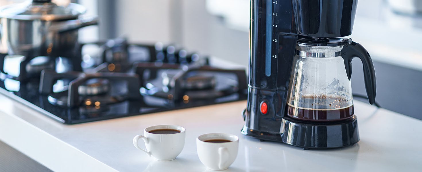 coffee maker and coffee cups on counter