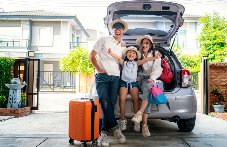 family sitting in trunk of suv for photo