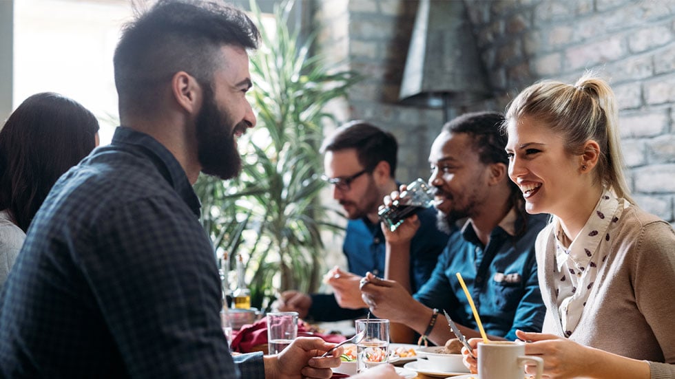 A group of coworkers eating lunch together
