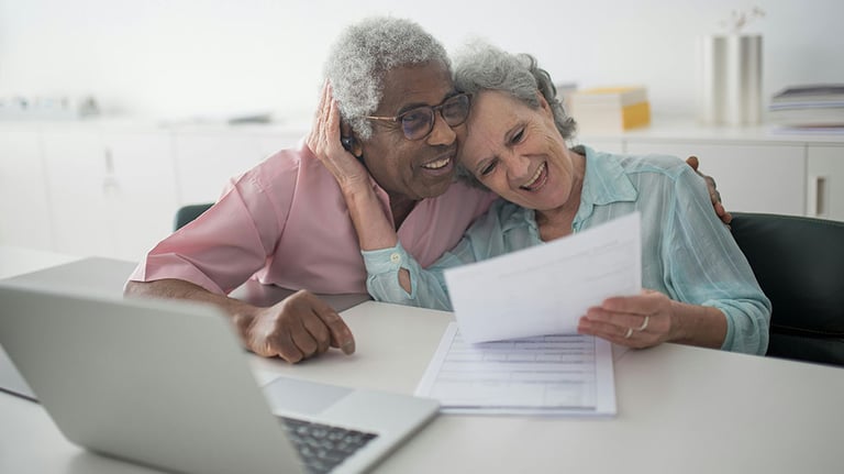A Happy Elderly Couple Holding a Document; Photo by Kampus Production/ Courtesy of Pexels