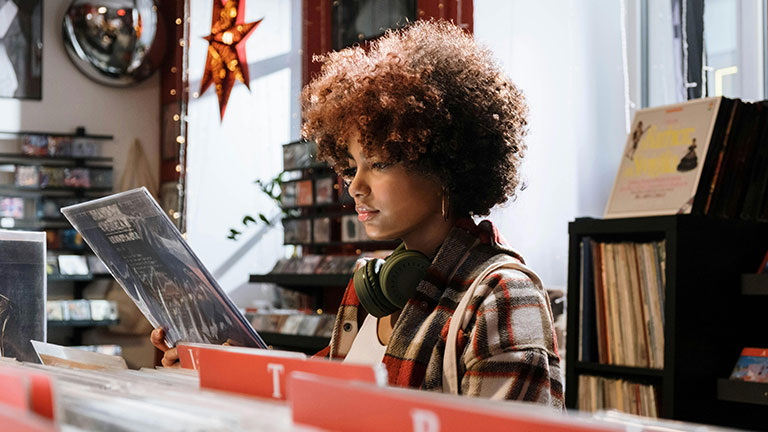 Woman in Red and White Plaid Shirt Checking the Vinyl Record Credit: cottonbro studio