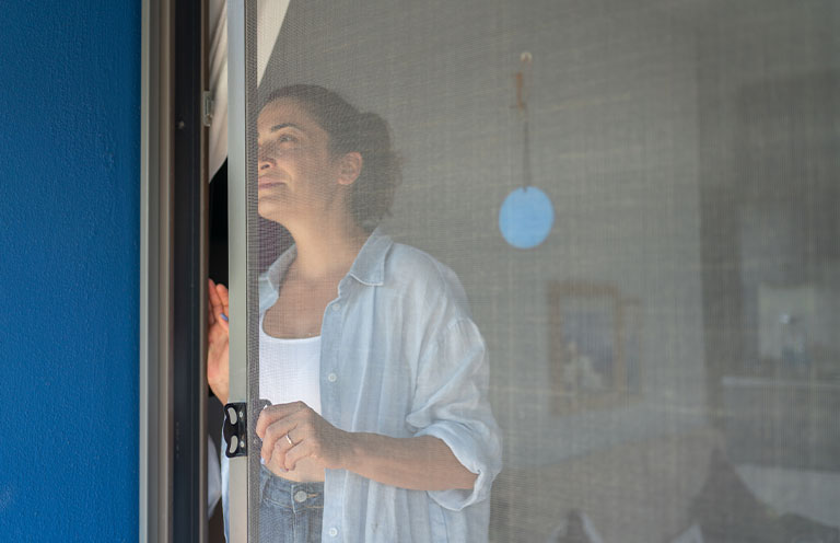 woman closing screen door