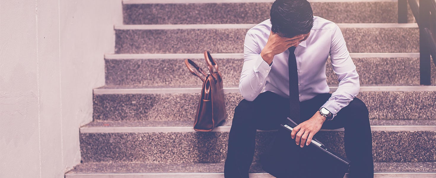 frustrated business man sitting on stairs