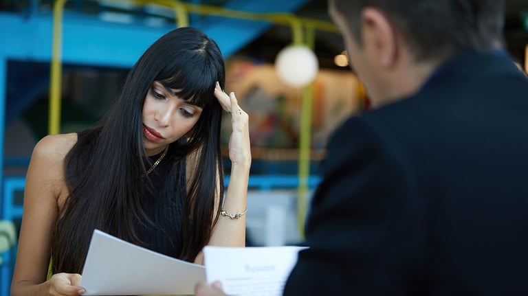 man and woman looking at resume
