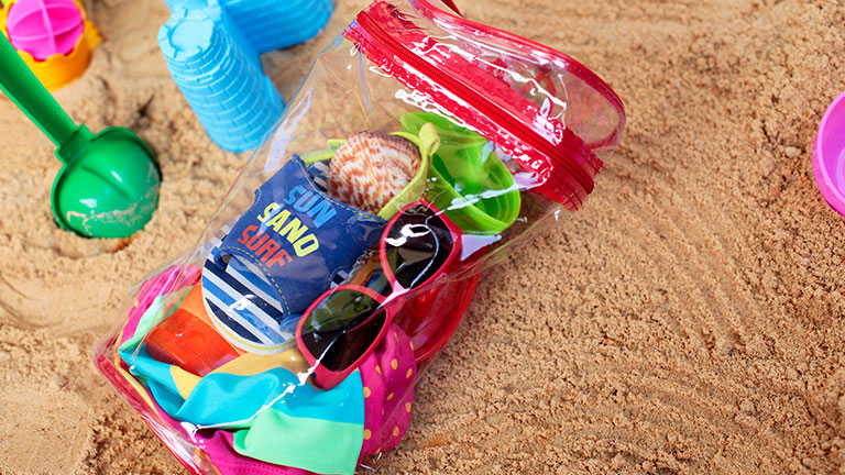 Transparent beach bag with necessary things for beach fun; Credit: zwolafasola
