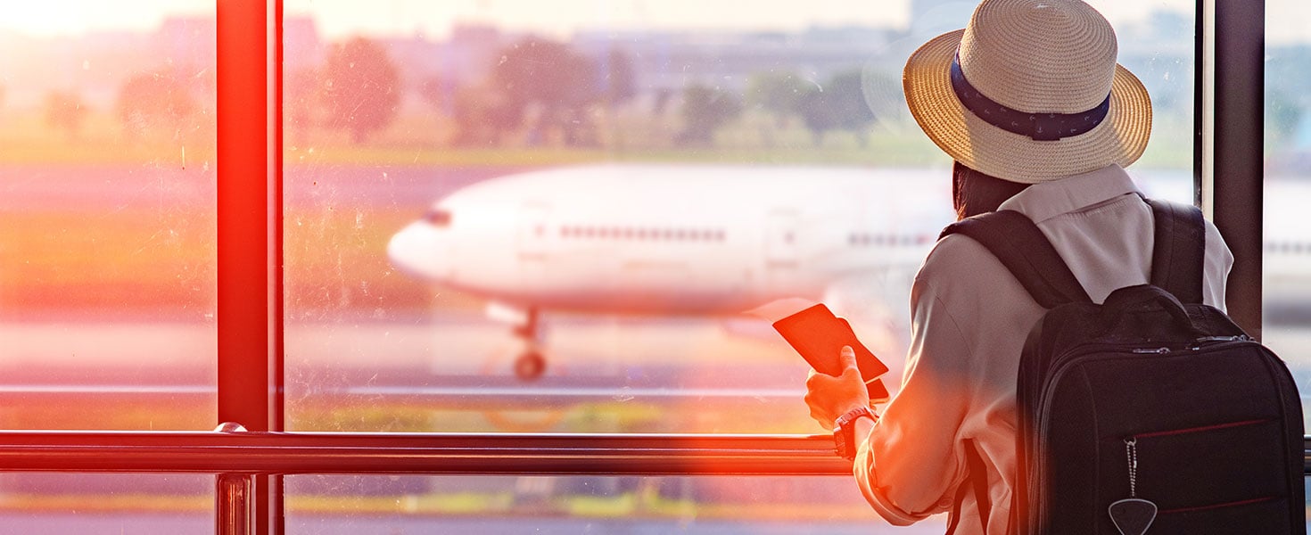 Woman holding passport waiting in transit area in the airport, standing by for the next schedule traveling, late delay of the arrival departure, missing checking in the boarding pass. By ID_Anuphon