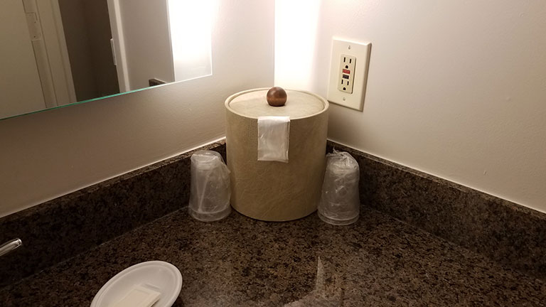 granite or marble bathroom counter with ice bucket and soap Credit:Justin Smith