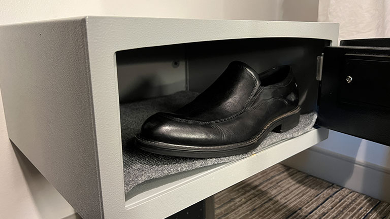 A shoe is placed in a safe in a hotel room, part of a viral internet video trend Credit:Tomsmith585