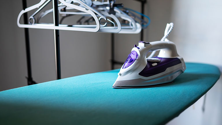 Iron standing on an ironing board. Credit:M-Production