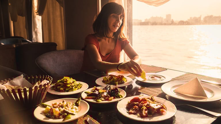 Woman holding a plate full of food. All inclusive concept. Credit: M-Production